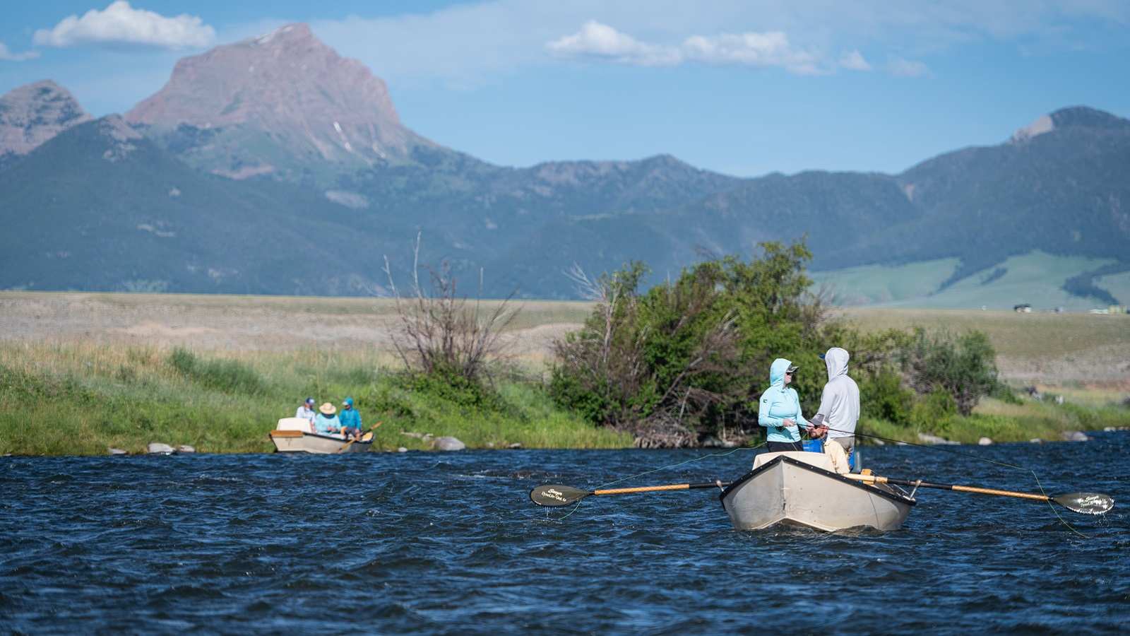 Two fly fishing boats float down a Montana river with guests during a trip with The Tackle Shop.